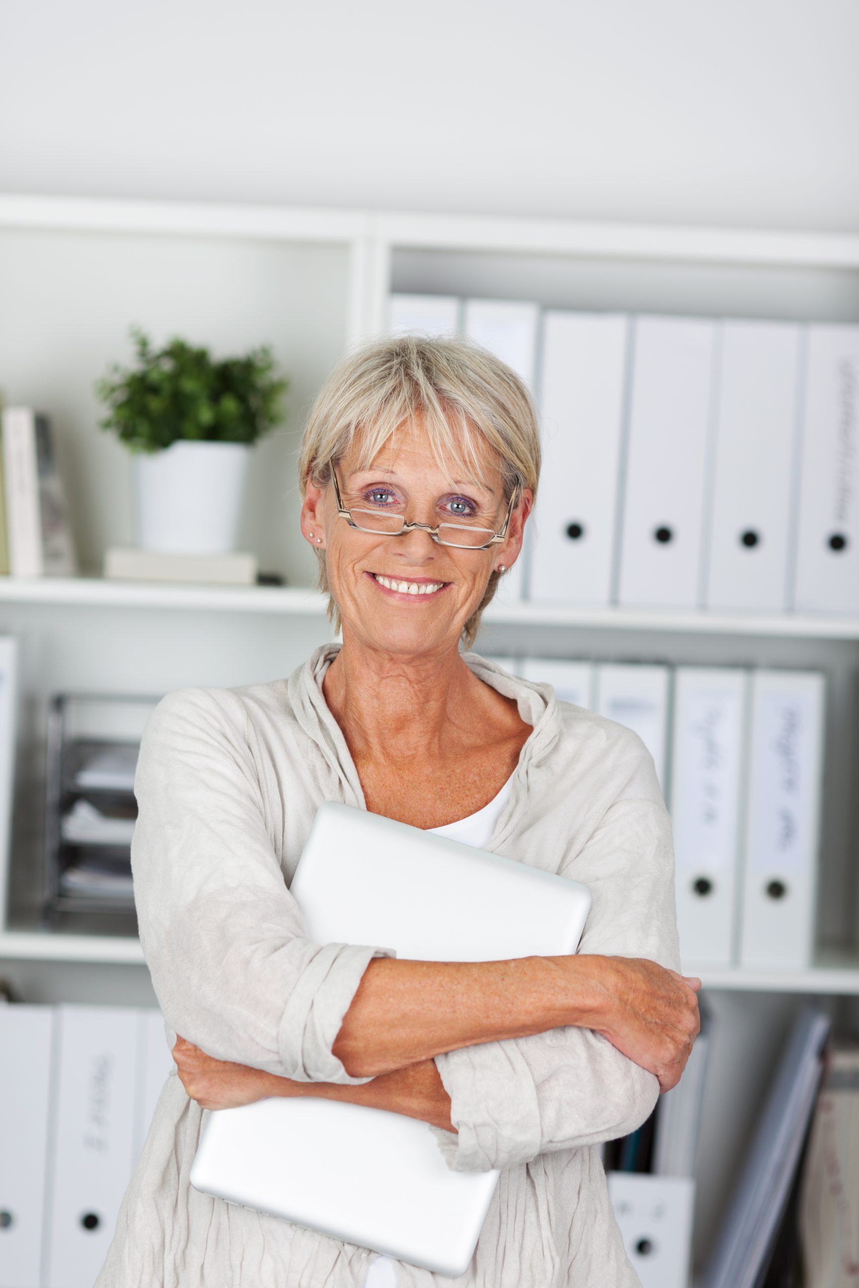 Good looking senior woman holding a laptop