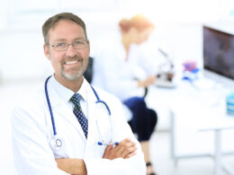 successful happy smiling male doctor with phonendoscope